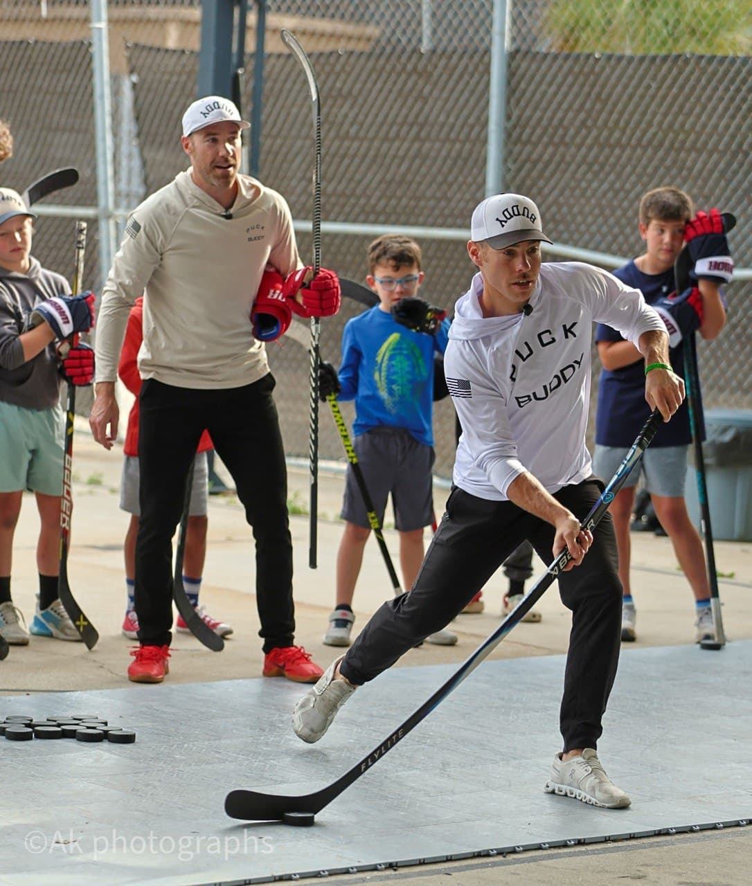Puck Buddy coaches working with players at a clinic.